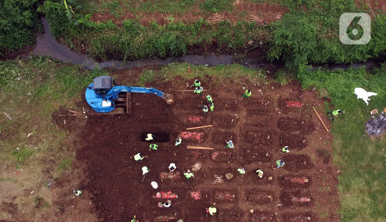 Foto udara memperlihatkan eksavator membantu proses penggalian makam jenazah dengan protokol COVID-19 di area khusus TPU Srengseng Sawah, Jakarta, Kamis (14/1/2021). Pada Selasa (12/1) lalu, 47 jenazah dimakamkan dengan protokol COVID-19 di TPU Srengseng Sawah. (Liputan6.com/Helmi Fithriansyah)