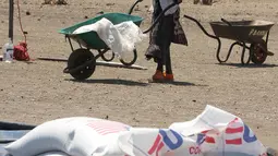 Seorang wanita mengambil bantuan makanan dari World Food Programme di Chiredzi Mupinga, Zimbabwe, Selasa (6/10). Puluhan juta orang di wilayah sub-Sahara Afrika akan mengalami kelaparan akibat siklus El Nino mencapai puncaknya. (REUTERS/Philimon Bulawayo)