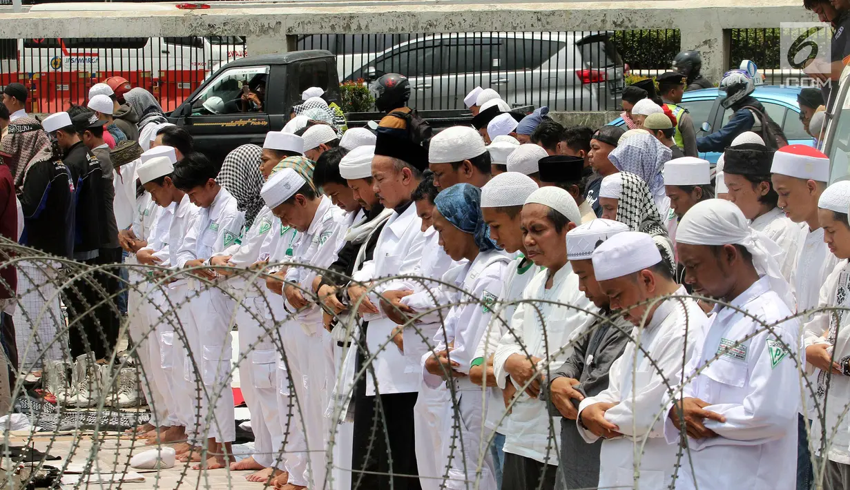Massa aksi 299 melakuan salat Jumat di depan Gedung MPR/DPR, Jakarta, Jumat (29/9). Aksi  tersebut menolak Peraturan Pemerintah Pengganti Undang-Undang Nomor 2 Tahun 2017 tentang Perppu Ormas. (Liputan6.com/Johan Tallo)