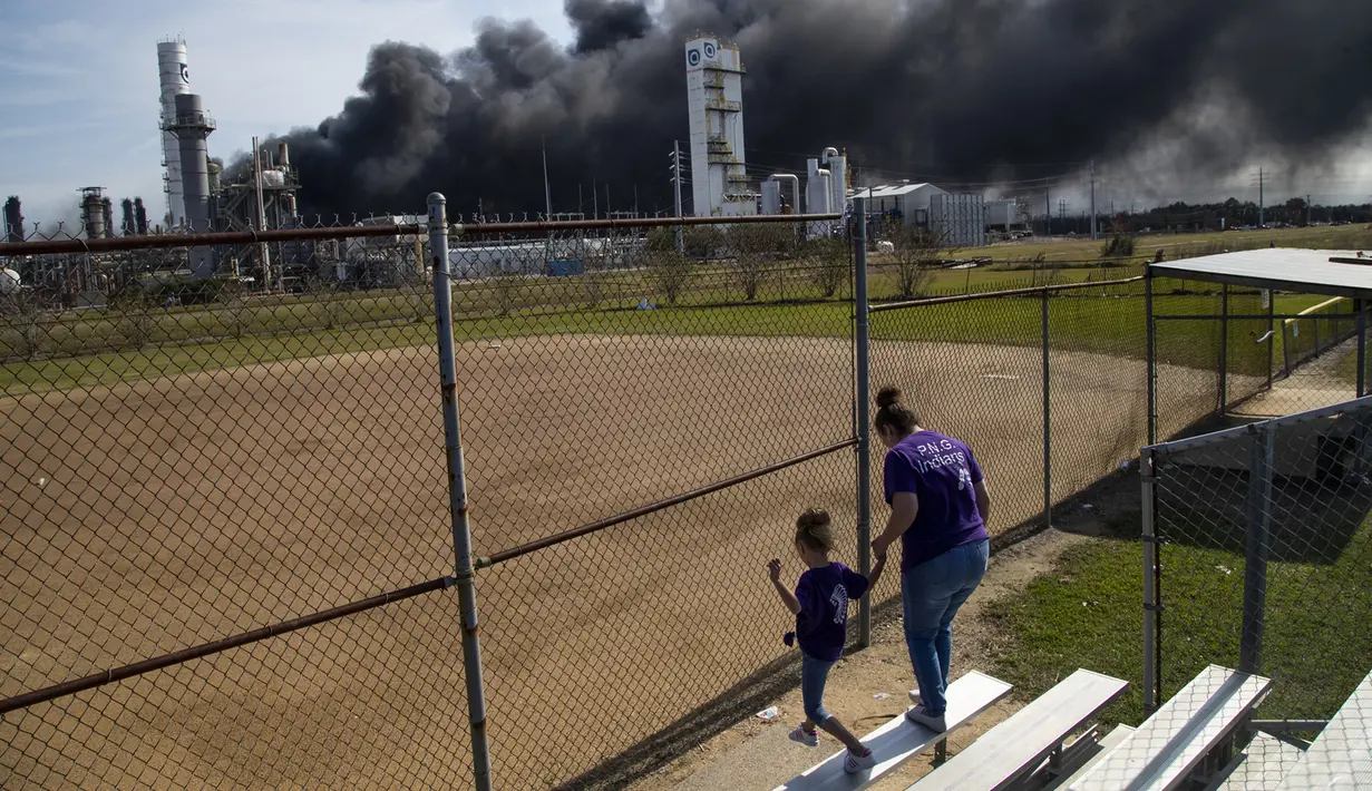Asap tebal terlihat di dekat lapangan bisbol setelah ledakan di TPC Group di Port Neches, Texas (27/11/2019). Saksi mata mengatakan ledakan yang terjadi pabrik kimia tersebut seperti sebuah bom. (Marie D. De Jesús/Houston Chronicle via AP)