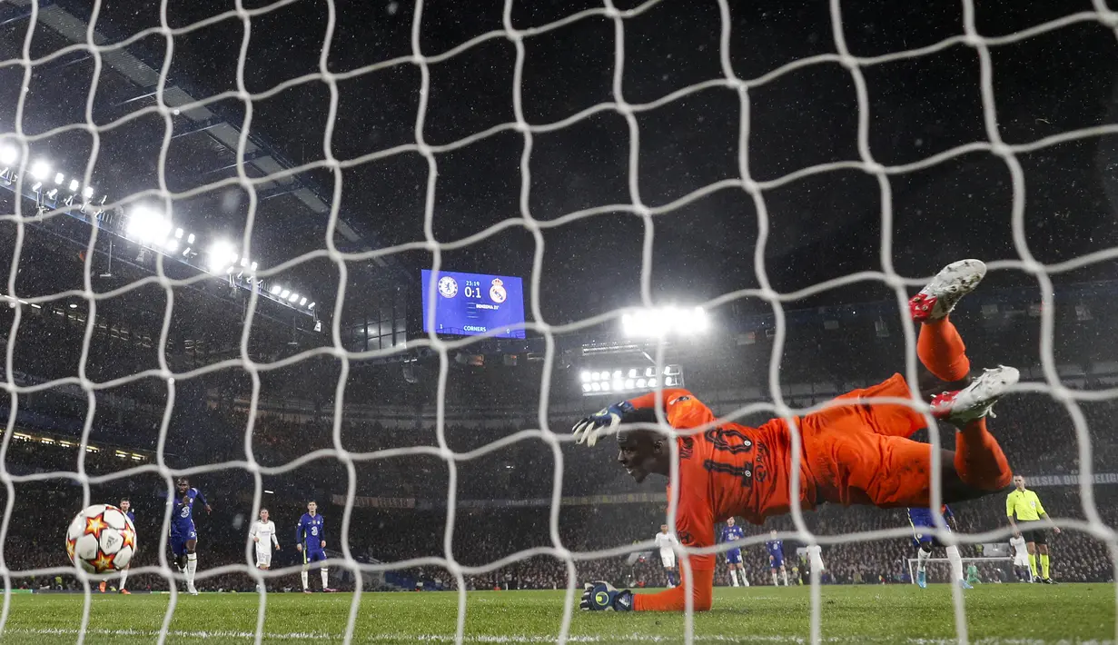 Tanpa ampun Benzema langsung mengirim bola ke gawang yang kosong. Mendy berusaha mengejar dan menekel Benzema, tetapi sia-sia. Gawang yang ditinggalkannya terlanjur bobol. (AFP/Adrian Dennis)