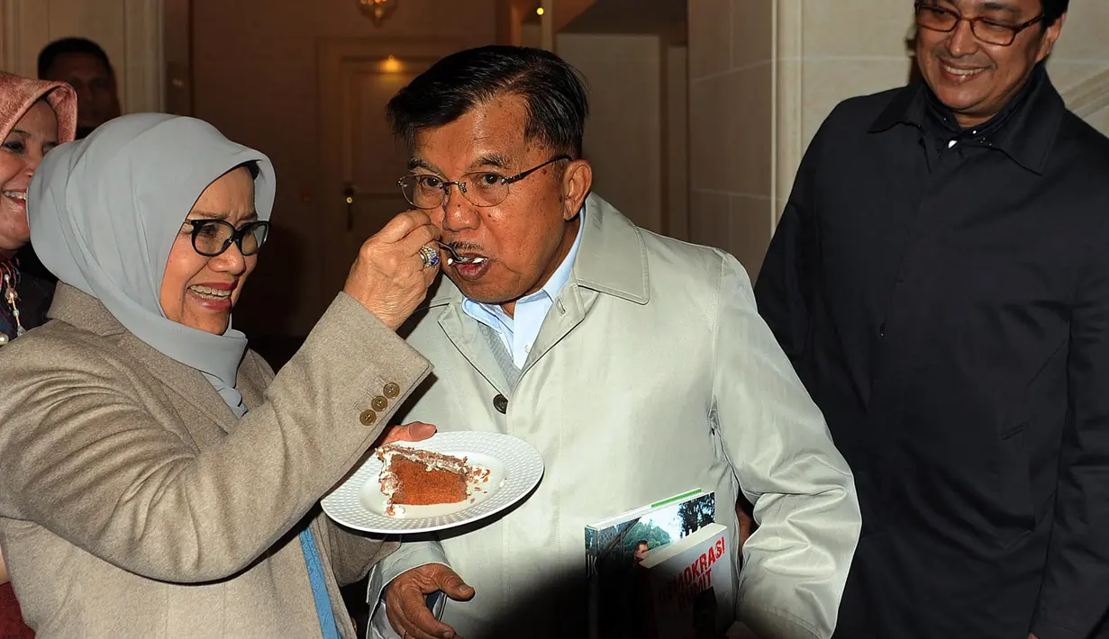 Mufidah Kalla menyuapi Wapres Jusuf Kalla saat syukuran ulang tahunnya ke-77 di Jenewa, Swiss, Rabu (15/5/2019). Kunjungan JK ke Swiss untuk menghadiri Forum PBB terkait pengurangan resiko kebencanaan atau Global Platform Disaster Risk Reduction United Nation. (Liputan6.com/Tim Media Wapres)