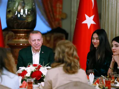 Gelandang Arsenal, Mesut Ozil didampingi kekasihnya Amine Gulse saat menghadiri acara buka puasa bersama dengan Presiden Turki Recep Tayyip Erdogan di Istana Dolmabahce, Istanbul, Turki (19/5). (Stringer/Turkish President's Press Office/AFP)