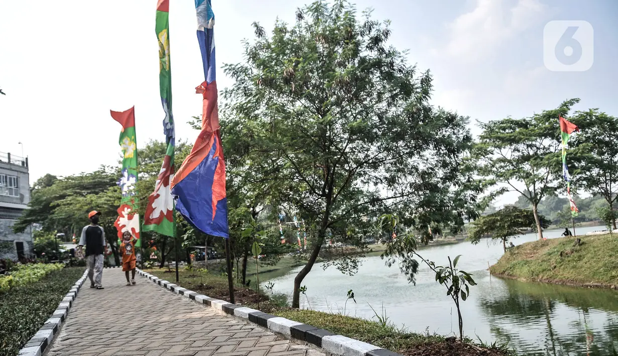 Warga  melintasi jogging track di Waduk Setu, Cipayung, Jakarta, Selasa (28/7/2020). Saat ini Waduk Setu tengah dibuat jalur olahraga dan juga akan dilengkapi sarana bermain anak serta pusat kuliner yang diharapkan meningkatkan potensi kawasan ekonomi pariwisata. (merdeka.com/Iqbal S. Nugroho)