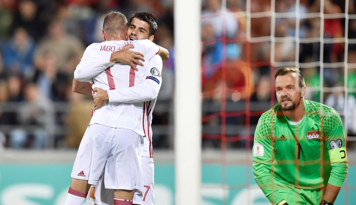Pemain Spanyol, Iago Aspas (tengah) merayakan gol bersama Alvaro Morata ke Liechtenstein yang di kawal Peter Jehle (kanan) pada laga grup G kualfikasi Piala DUnia 2018 di Rheinpark Stadion, Vaduz, (5/9/2017). Spanyol menang 8-0. (AFP/Michael Buholzer)
