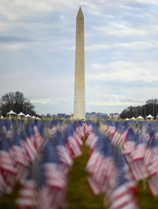 Ribuan bendera terlihat di National Mall menjelang upacara pelantikan Joe Biden sebagai presiden Amerika Serikat (AS) ke-46 di Washington, DC., Senin (18/1/2021). Washington DC biasanya dipenuhi ratusan ribu orang, tetapi kini sangat sepi jelang hari besar Biden. (Eric BARADAT/AFP)