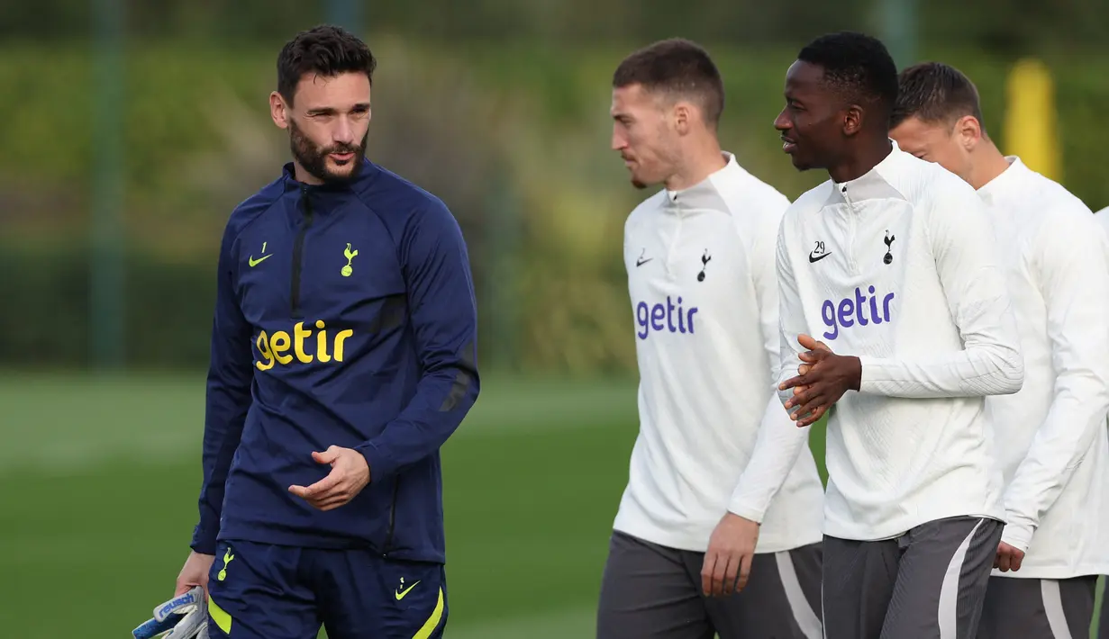 Penjaga gawang Tottenham Hotspur, Hugo Lloris (kiri) berbicara dengan bek Matt Doherty dan gelandang Pape Matar Sarr selama sesi latihan tim di Tottenham Hotspur Football Club Training Ground di London utara pada Oktober 31 Oktober 2022. (AFP/Adrian Dennis)