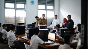 Presiden Joko Widodo ditemani Mendikbud Anies Baswedan dan Gubernur DKI Jakarta Basuki Tjahaja Purnama (Ahok) meninjau pelaksanaan Ujian Nasional (UN) di SMKN 1, Jakarta, Selasa (14/4/2015). (Liputan6.com/Faizal Fanani)