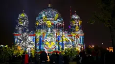 Sejumlah wisatawan mengamati Katedral Berlin yang dihiasi cahaya saat Festival Cahaya di Berlin, Jerman, Sabtu (10/10/2015). Festival ini merupakan event tahunan yang diadakan setiap bulan Oktober selama dua belas hari.(REUTERS/Hannibal Hanschke)