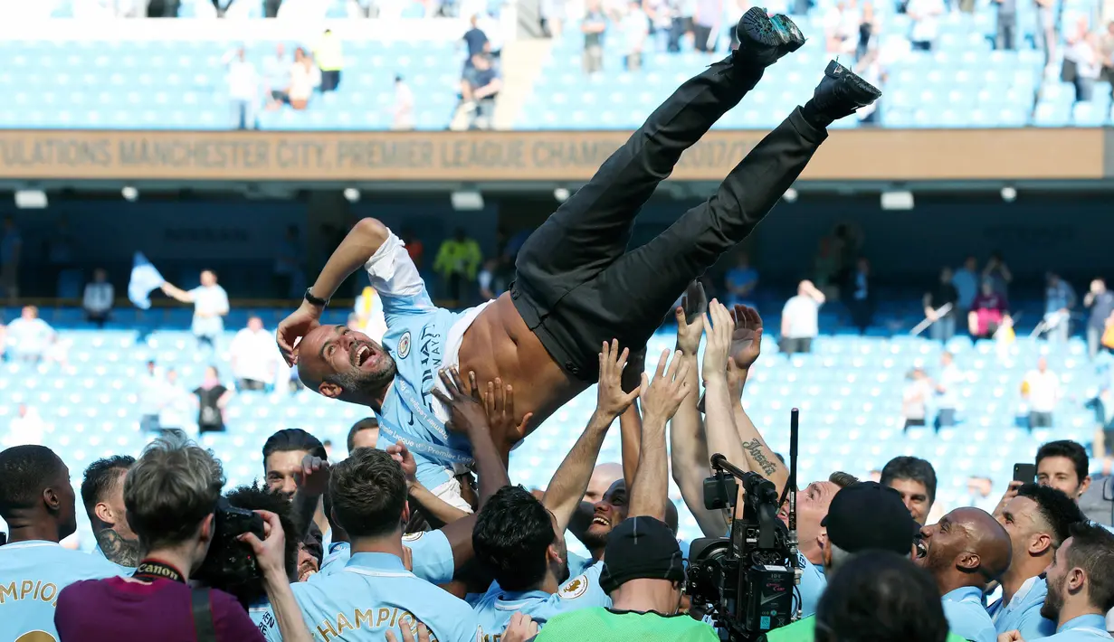 Ekspresi Manajer Manchester City Pep Guardiola saat merayakan gelar juara Liga Inggris di Etihad Stadium (6/5). Saat ini City mengumpulkan 94 poin dan telah menceploskan 102 gol. (AP Photo/Rui Vieira)
