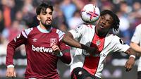 Pemain Southampton, Romeo Lavia (kanan) berebut bola dengan pemain West Ham United, Lucas Paqueta pada laga lanjutan Liga Inggris 2022/2023 di London Stadium, London, Inggris, 2 April 2023. Gelandang asal Belgia tersebut kini memiliki nilai pasar sebesar 25 juta euro. Ia masih terikat kontrak dengan The Saint hingga 2027. (AFP/Glyn Kirk)