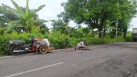Gufron, seorang tukang becak asal Desa Dinoyo, Kecamatan Deket, Lamongan, Jawa Timur, sedang memperbaiki lubang jalan (merdeka.com)