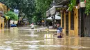 Seorang pria terlihat berdiri di jalanan yang terendam banjir setelah hujan deras di Hoi An, Vietnam, Kamis 30 Oktober 2025. Badan Meteorologi Vietnam memperkirakan hujan deras masih akan mengguyur wilayah tengah negara itu selama dua hari ke depan, dengan curah hujan di beberapa lokasi diperkirakan tetap di atas 400 milimeter mulai Rabu (29/10) pagi hingga Kamis (30/10/2025) malam waktu setempat. (NHAC NGUYEN/AFP)