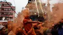 Seorang anak menaburkan bubuk vermillion saat perayaan sindoor Jatra festival di Bhaktapur, Nepal (15/4). Perayaan ini untuk menyambut datangnya musim semi dan Tahun Baru. (AP Photo/Niranjan Shrestha)