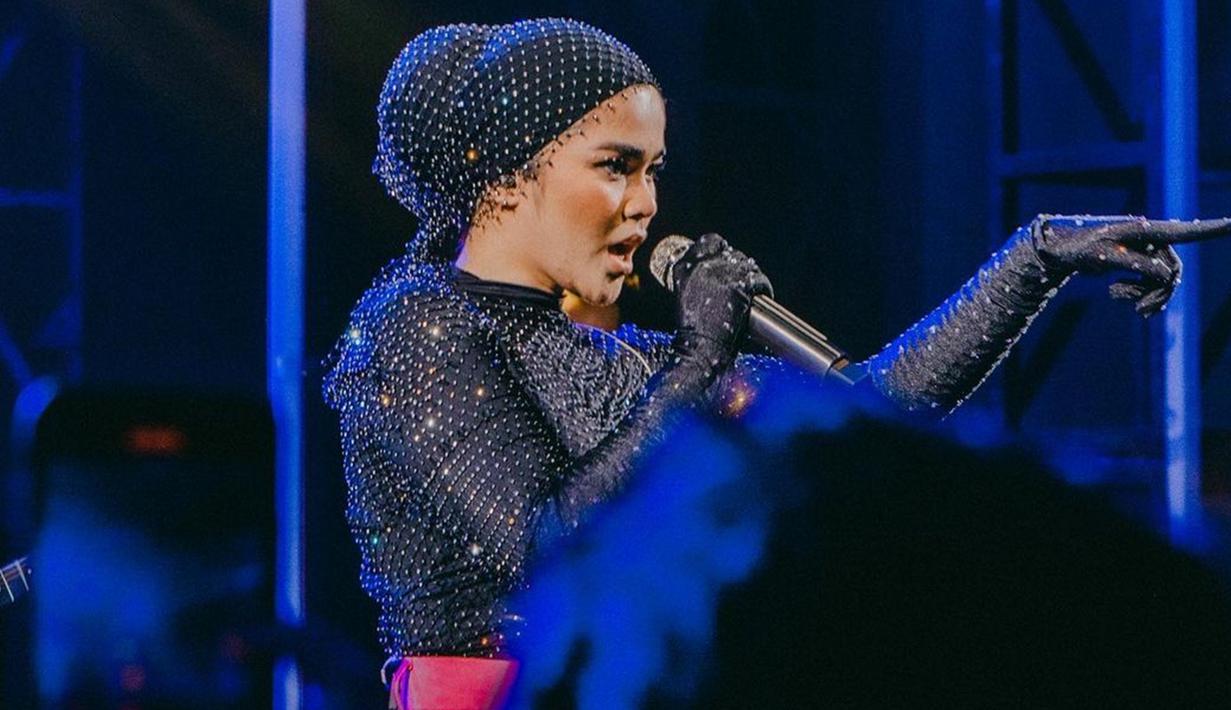 Selalu tampil nyentrik dan berbeda, penampilan Sivia Azizah saat manggung kerap mencuri perhatian. Penyanyi berusia 25 tahun ini juga selalu berhasil mengajak penonton untuk menikmati lagu dan bernyanyi bersamanya. Selain nyentrik, penyanyi sekaligus penulis lagu ini juga identik dengan penampilan boyish. Padu padan pakaian yang dikenakan Sivia punya daya tarik tersendiri. (Liputan6.com/IG/@siviazizah)