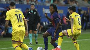 Jules Kounde (Barcelona) berebut bola dengan Diego Rico dan Mauro Arambarri (Getafe) dalam laga La Liga Spanyol di Johan Cruyff Stadium, Spanyol, 21 September 2025. (AP Photo/Joan Monfort)