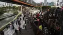 Warga mengisi libur Tahun Baru dengan menikmati pemandangan Kota Jakarta dari Skywalk Senayan Park, Sabtu (1/1/2022). Warga ramai-ramai datang untuk berburu foto pada spot-spot yang instagramable di Skywalk Senayan Park. (Liputan6.com/Johan Tallo)