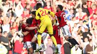 Kiper MU, Andre Onana (tengah), ikut melakukan selebrasi bersama rekan-rekannya setelah Scott McTominay mencetak gol kemenangan Manchester United atas Brentford dalam laga pekan kedelapan Liga Inggris 2023/2024 yang berlangsung di Old Trafford, Sabtu (8/10/2023). (AFP/Darren Staples)