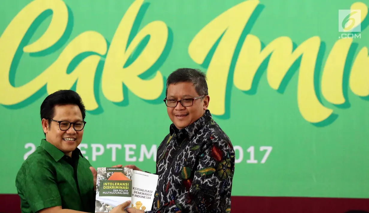 Ketua Umum PKB Muhaimin Iskandar secara simbolis memberikan buku kepada Sekjen Partai PDI Hasto Kristiyanto  saat merayakan ulang tahunnya yang ke-51 sekaligus melauncing dua buku di Kantor DPP PKB, Jakarta, Minggu (24/9). (Liputan6.com/Johan Tallo)