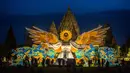 Orang-orang berkumpul di depan "Sunflower Angel", instalasi seni fiberglass setinggi sembilan meter karya seniman lokal Arrofi Ramadhan, di Candi Prambanan, kompleks candi Hindu abad ke-9 yang terdaftar sebagai Situs Warisan Dunia UNESCO, Sleman, Yogyakarta, pada Sabtu 6 Juni 2026. (DEVI RAHMAN/AFP)