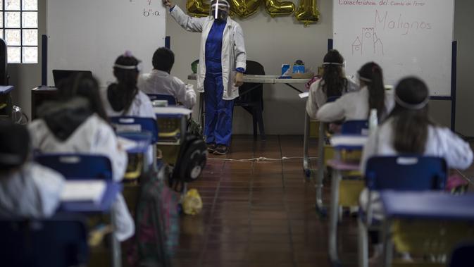 Suasana pada hari pertama kembali ke kelas tatap muka sejak Maret 2020 di Liceo Lunita, sebuah sekolah swasta di Chia di pinggiran Bogota, Kolombia, Jumat (5/2/2021). Sejauh ini Kolombia melaporkan lebih dari 2,13 juta kasus Covid-19, termasuk lebih dari 55.100 kematian. (AP Photo/Ivan Valencia)