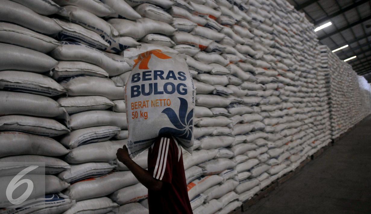 Pekerja memanggul karung Beras milik Badan Urusan Logistik (Bulog) di Gudang Bulog kawasan Kelapa Gading, Jakarta Utara, Selasa (7/6). Bulog memiliki stok beras sebanyak 2,1 juta ton. (Liputan6.com/Johan Tallo)