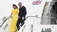 Kate Middleton dan Pangeran William turun dari pesawat setibanya di Bandara Internasional Norman Manley di Kingston saat mereka mengunjungi Jamaika untuk menandai Jubilee Platinum Yang Mulia Ratu pada 22 Maret 2022. (RICARDO MAKYN / AFP)