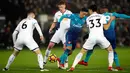 Pemain Arsenal, Mesut Ozil berusaha merebut bola dengan kawalan pemain Swansea City dalam laga pekan ke-25 Premier League 2017-2018 di Liberty Stadium, Selasa (30/1). Arsenal dipaksa menyerah Swansea City 1-3. (Nick Potts/PA via AP)