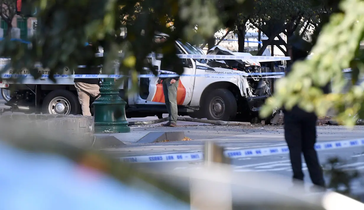 Petugas kepolisian memeriksa sebuah truk yang menabrak pejalan kaki dan pesepeda di Lower Manhattan, New York, Selasa (31/10). Polisi sudah menetapkan pelaku yang bernama Sayfullo Saipov (29) sebagai tersangka dalam kasus ini. (Don EMMERT/AFP)