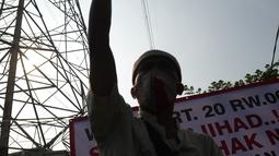 Warga mengepalkan tangan saat petugas gabungan melakukan eksekusi lahan rumah warga Kelurahan Pulogebang RT 20 RW 06 (dahulu RT 08/RW 06) di Jakarta, Selasa (8/6/2021). Eksekusi lahan tersebut berakhir ricuh. (merdeka.com/Imam Buhori)