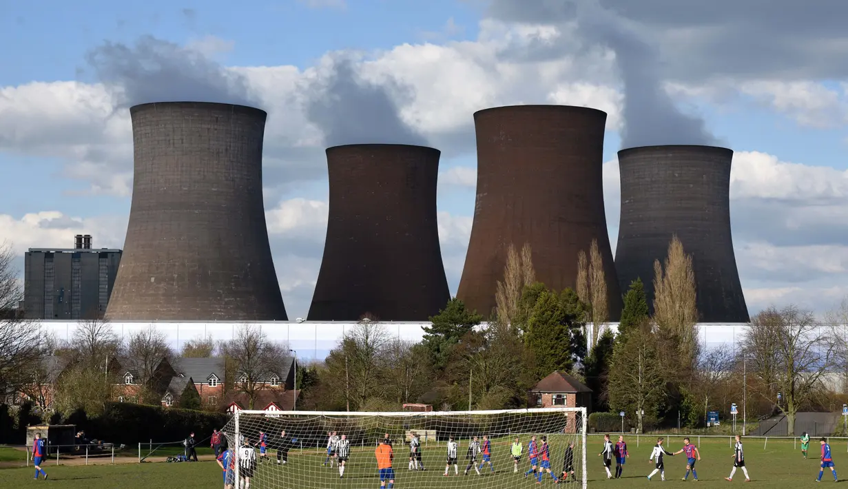 <p>Lapangan sepak bola milik Brereton Town FC ini mempunyai latar belakang Pembangkit Listrik Tenaga Batubara Rugeley di Inggris. Klub dengan julukan The Ravens tersebut telah membangun stadion kecil mereka sejak tahun 1899. (AFP/Oli Scarff)</p>