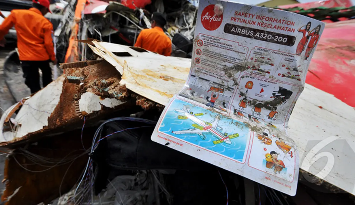 Sebuah buku petunjuk keselamatan ditemukan di dalam bangkai badan pesawat Airasia QZ8501, Pelabuhan Tanjung Priok, Jakarta, Senin (2/3/2015).  (Liputan6.com/Faizal Fanani)