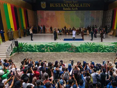 Warga menyaksikan sebelas pria dan wanita menjalani hukuman cambuk setelah dinyatakan bersalah melanggar hukum syariat Islam Aceh yang melarang hubungan seksual di luar nikah di Banda Aceh, Kamis, 20 Agustus 2026. (AFP/ Chaideer Mahyuddin)