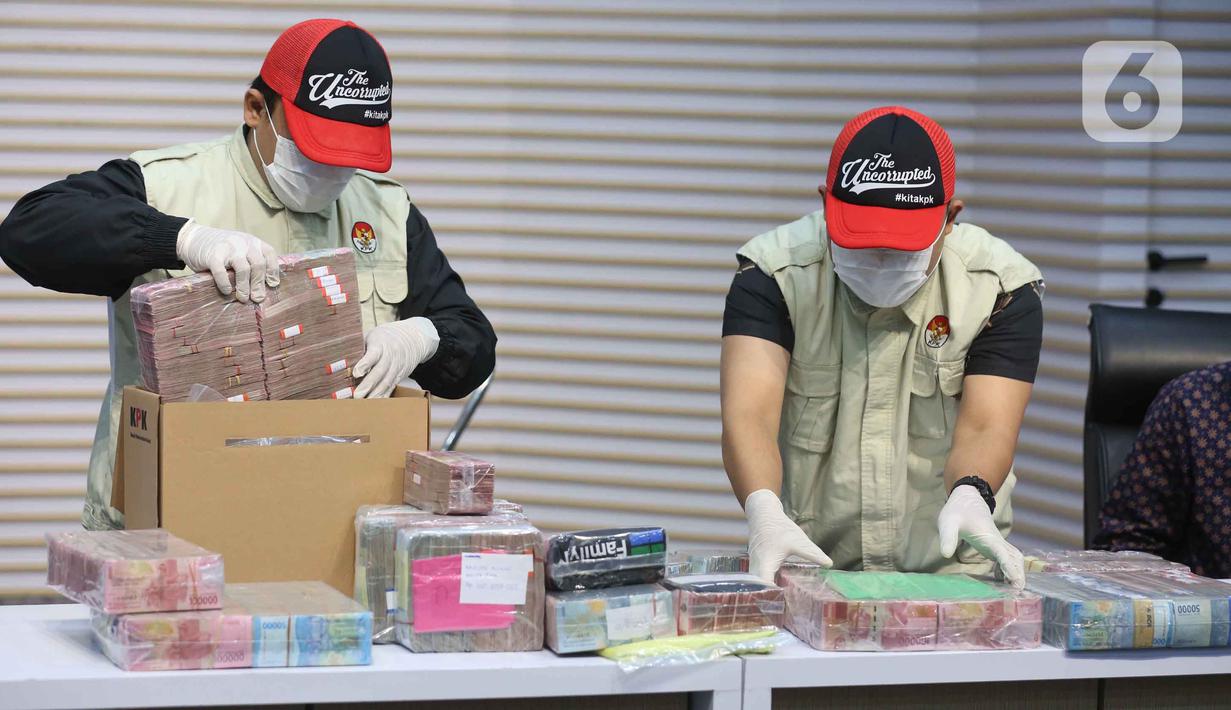 Dalam operasi tersebut, KPK menangkap delapan orang, termasuk Bupati Sudewo, dua camat, tiga kepala desa, dan dua calon perangkat desa di lingkungan Kabupaten Pati Jawa Tengah. Tampak dalam foto, petugas menyusun tumpukan uang barang bukti Operasi Tangkap Tangan (OTT) Bupati Pati Sudewo di Gedung Merah Putih Komisi Pemberantasan Korupsi (KPK), Jakarta, Selasa (20/1/2026). (Liputan6.com/Helmi Fithriansyah)