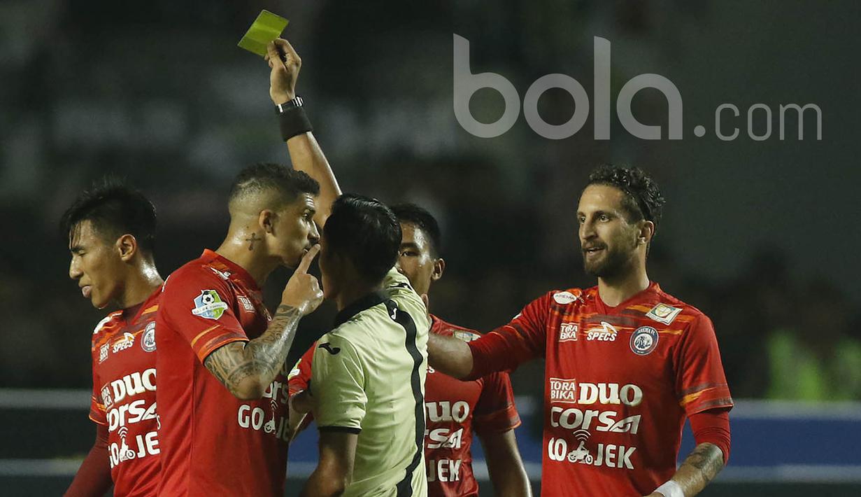 Bek Arema FC, Arthur Cunha, protes kepada wasit yang memberikan kartu kuning kepada Hanif Sjahbandi saat melawan Persib Bandung pada laga Liga 1 di Stadion GBLA Bandung, Jawa Barat, Sabtu (15/4/2017). (Bola.com/M Iqbal Ichsan)