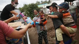 Anak-anak menerima makanan ringan dari relawan di sekitar tenda Posko Pengungsi Rendang, Bali, Sabtu (2/12). (Liputan6.com/Immanuel Antonius)