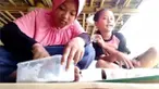 Dua anak perempuan menunjukkan cara membuat slime. Di tengah proses pembuatan salah satu dari mereka tercebur ke kolam.