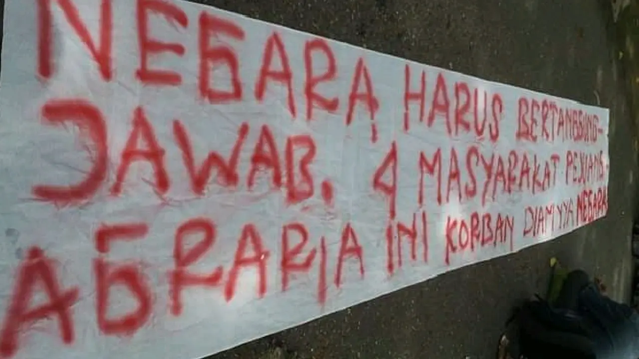 Spanduk warga yang dipampang warga Gampong Cot Mee, Kabupaten Nagan Raya, saat menggelar aksi mendesak dibebaskannya empat orang warga desa tersebut yang ditahan polisi akibat konflik agraria pada 2015 silam (Liputan6.com/Rino Abonita)