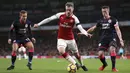 Gelandang Arsenal, Aaron Ramsey, berusaha melewati penjagaan pemain Huddersfield pada laga Premier League di Stadion Emirates, London, Rabu (29/11/2017). Arsenal menang 5-0 atas Huddersfield. (AP/Nigel French)