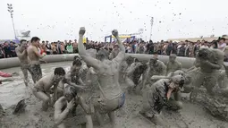 Suasana Festival Lumpur Boryeong ke-20 di Pantai Daecheon di Boryeong, Korea Selatan (21/7). Festival lumpur tahunan ke-20 ini selalu mengadakan berbagai perlombaan yang menggunakan arena berlumpur. (AP Photo/Ahn Young-joon)