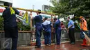 Petugas membongkar seng-seng yang menghiasi depan gerai Starbucks, Jalan MH Thamrin, Jakarta, Jumat (15/1). Sebelumnya, pasca-ledakan pada Kamis (14/1), pihak pengelola Menara Cakrawala memagari sekeliling gedung dengan seng. (Liputan6.com/Faizal Fanani)