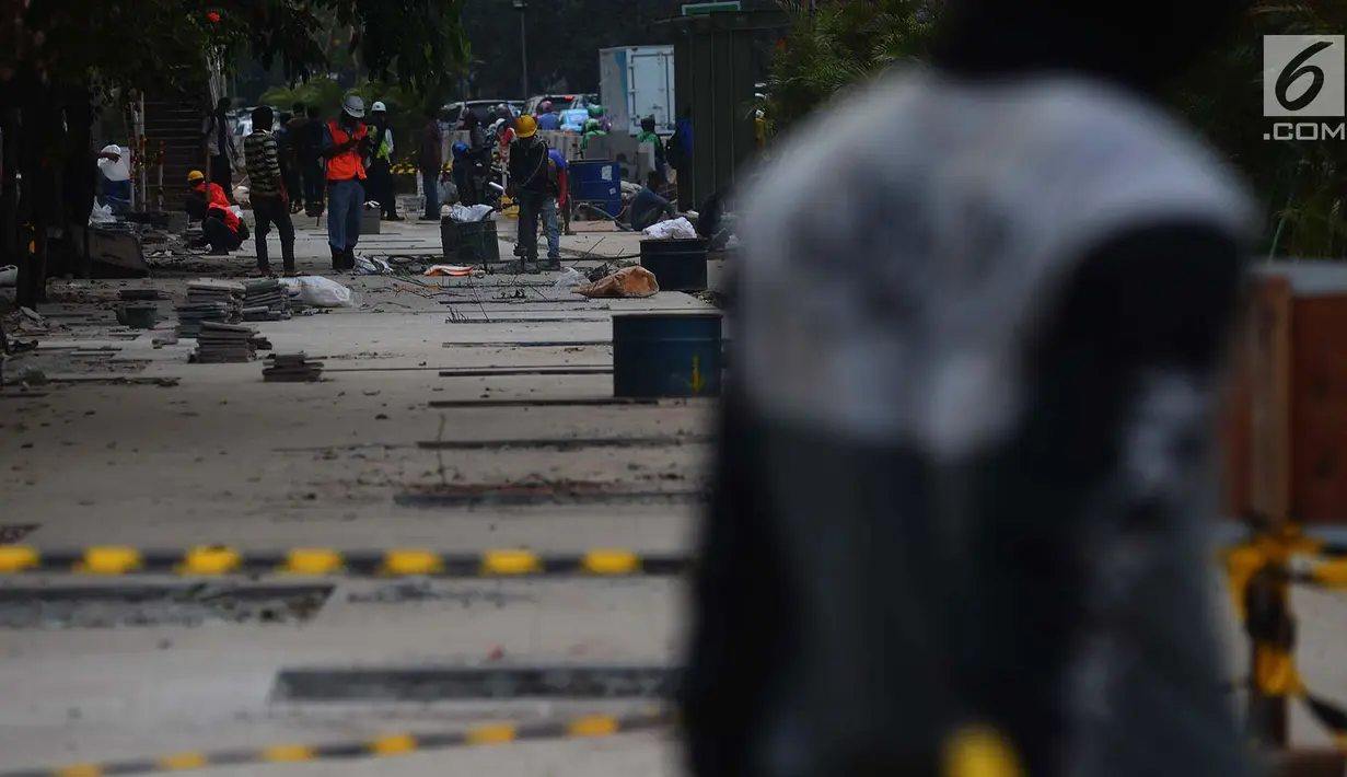 Pekerja menyelesaikan penataan jalur pedestrian di sepanjang Jalan Jenderal Sudirman - Jalan MH Thamrin, Jakarta, Selasa (10/7). Pelebaran trotoar untuk mendukung perhelatan Asian Games itu  hingga kini belum rampung. (Merdeka.com/Imam Buhori)