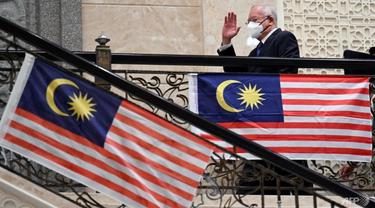 Mantan Perdana Menteri Malaysia Najib Razak melambaikan tangan saat tiba di pengadilan federal di Putrajaya pada 15 Agustus 2022. (Foto: AFP/Mohd Rasfan)