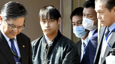 Kabu Terauchi (kedua kiri) dikawal petugas meninggalkan rumah sakit menuju kantor polisi di Izunokuni, Jepang, Kamis (31/3). Pria 23 tahun itu ditangkap lantaran menyekap gadis remaja selama dua tahun di dalam apartemen miliknya. (REUTERS/Kyodo)