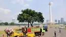 Beberapa truk dikerahkan untuk mengangkuti sampah yang mulai menggunung di kawasan Monumen Nasional, Jakarta, (31/7/2014). (Liputan6.com/Faizal Fanani)