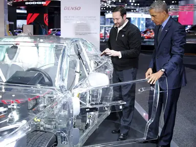 Presiden AS Barack Obama membuka pintu depan mobil transparan saat dipamerkan di North American International Auto Show di Detroit, Michigan (20/1). Obama terkagum melihat sebuah mobil transparan yang dipamerkan. (REUTERS/Jonathan Ernst)