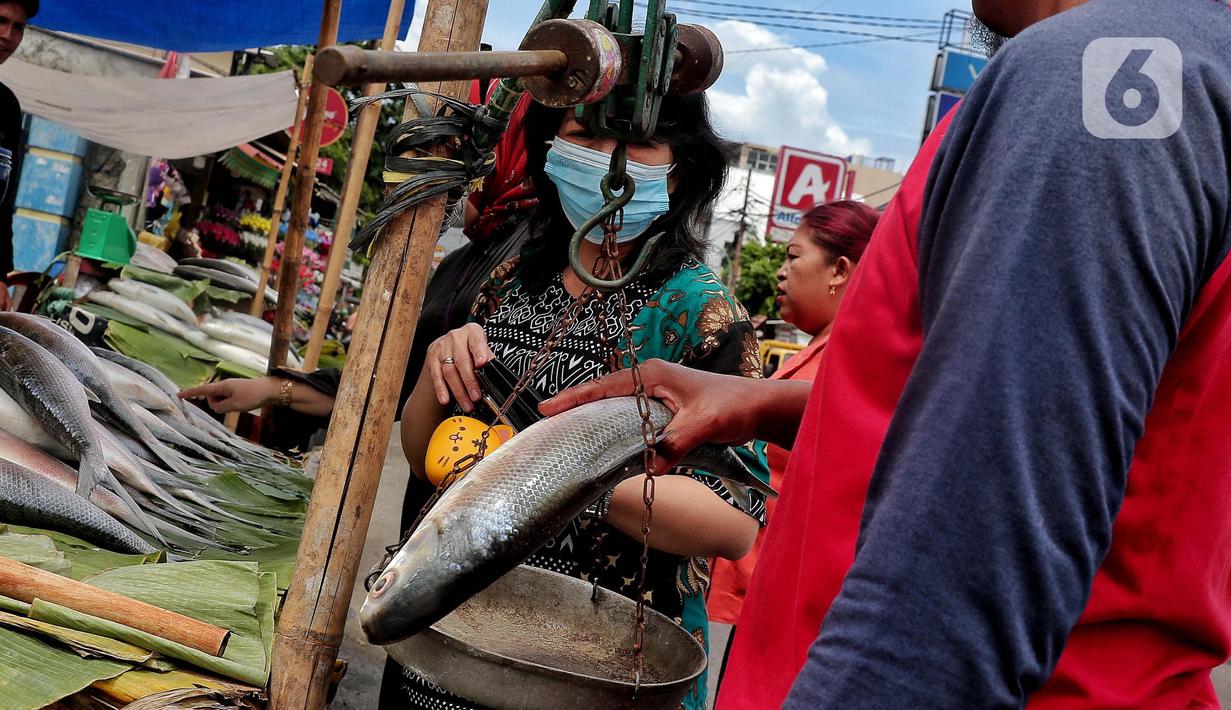 Pedagang menimbang ikan bandeng yang di jual di Rawa Belong, Jakarta, Jumat (20/1/2023). Penjual bandeng musiman ini menjual daganganya jelang perayaan Imlek yang dijual dengan harga mulai dari Rp. 50.000 hingga Rp. 90.000 per kilonya. (Liputan6.com/Angga Yuniar)