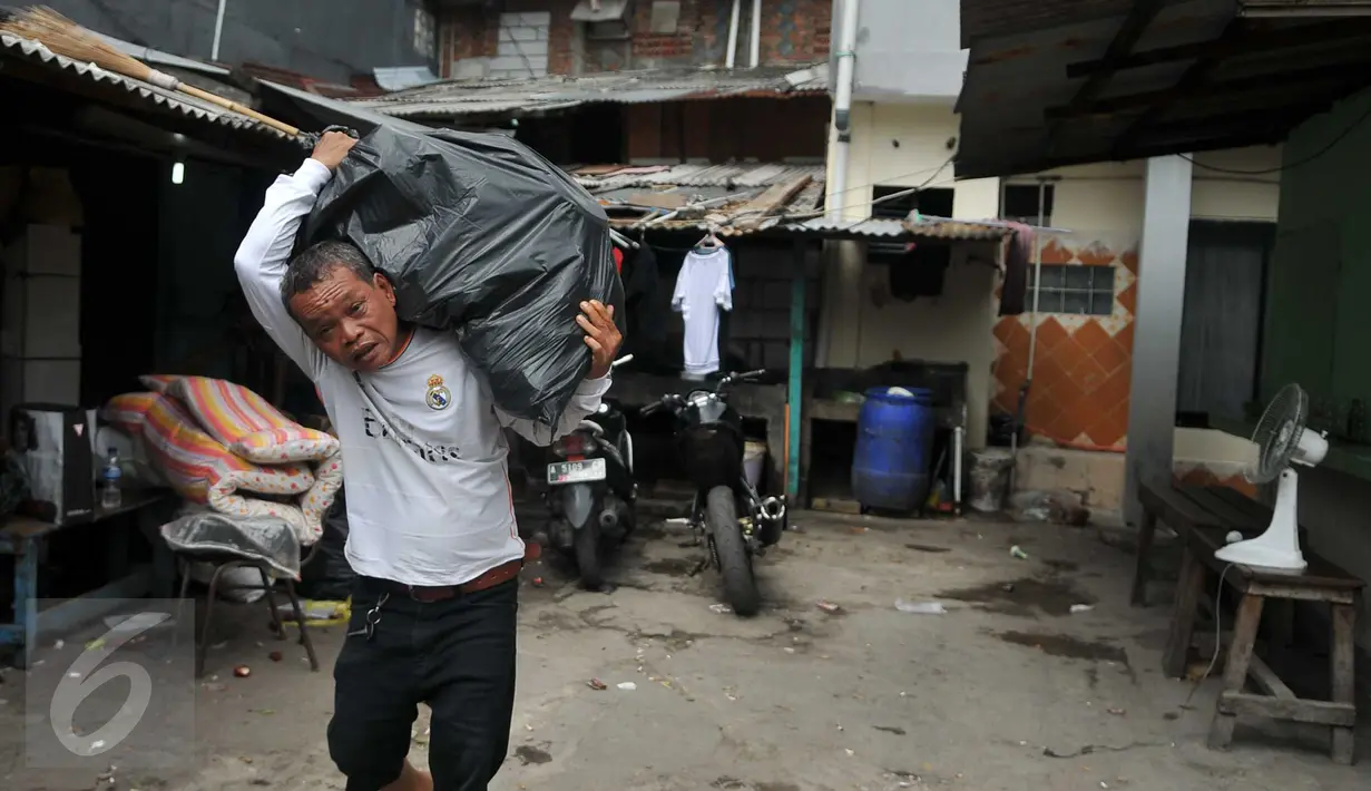 Warga memanggul plastik berisi barang miliknya dari rumah yang akan dibongkar di kawasan Kalijodo, Jakarta, Kamis (18/2). Gubernur DKI hari ini mengirim SP 1 kepada warga untuk mengosongkan dan membongkar sendiri rumah mereka (Liputan6.com/Gempur M Surya)