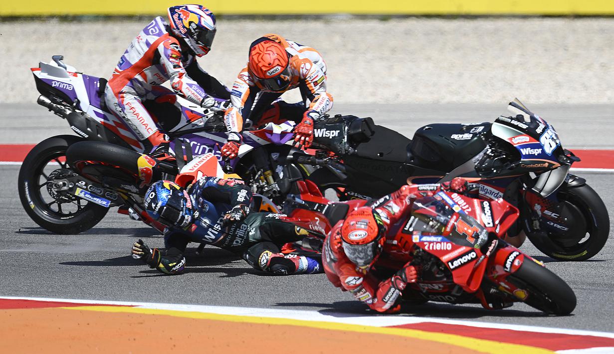 <p>Pembalap motor Honda, Marc Marquez (tengah atas) bertabrakan dengan pembalap Aprilia, Miguel Oliveira (tengah bawah saat MotoGP Portugal 2023 di Algarve International Circuit, Portimao, Portugal, 26 Maret 2023. (AFP/Patricia De Melo Moreira)</p>