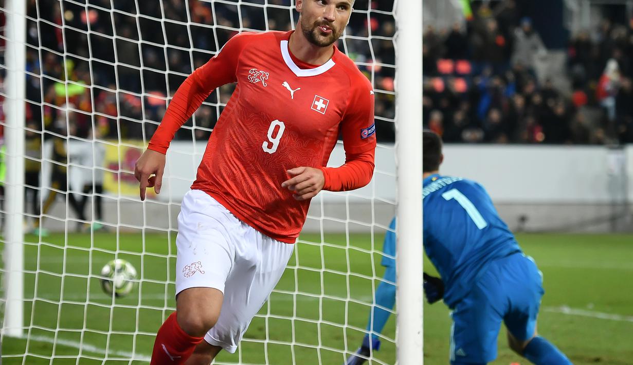 Bomber timnas Swiss Haris Saferovic menjadi bintang dengan tiga gol yang berhasil disarangkan ke gawang Belgia pada laga Nations League yang berlangsung di stadion Swissporarena, Senin (19/11). Timnas Swiss menang 5-2. (AFP/Fabrice Coffrini)